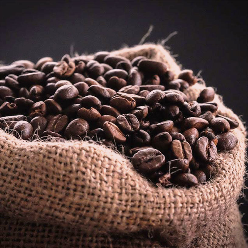 Open burlap sack of roasted coffee beans.