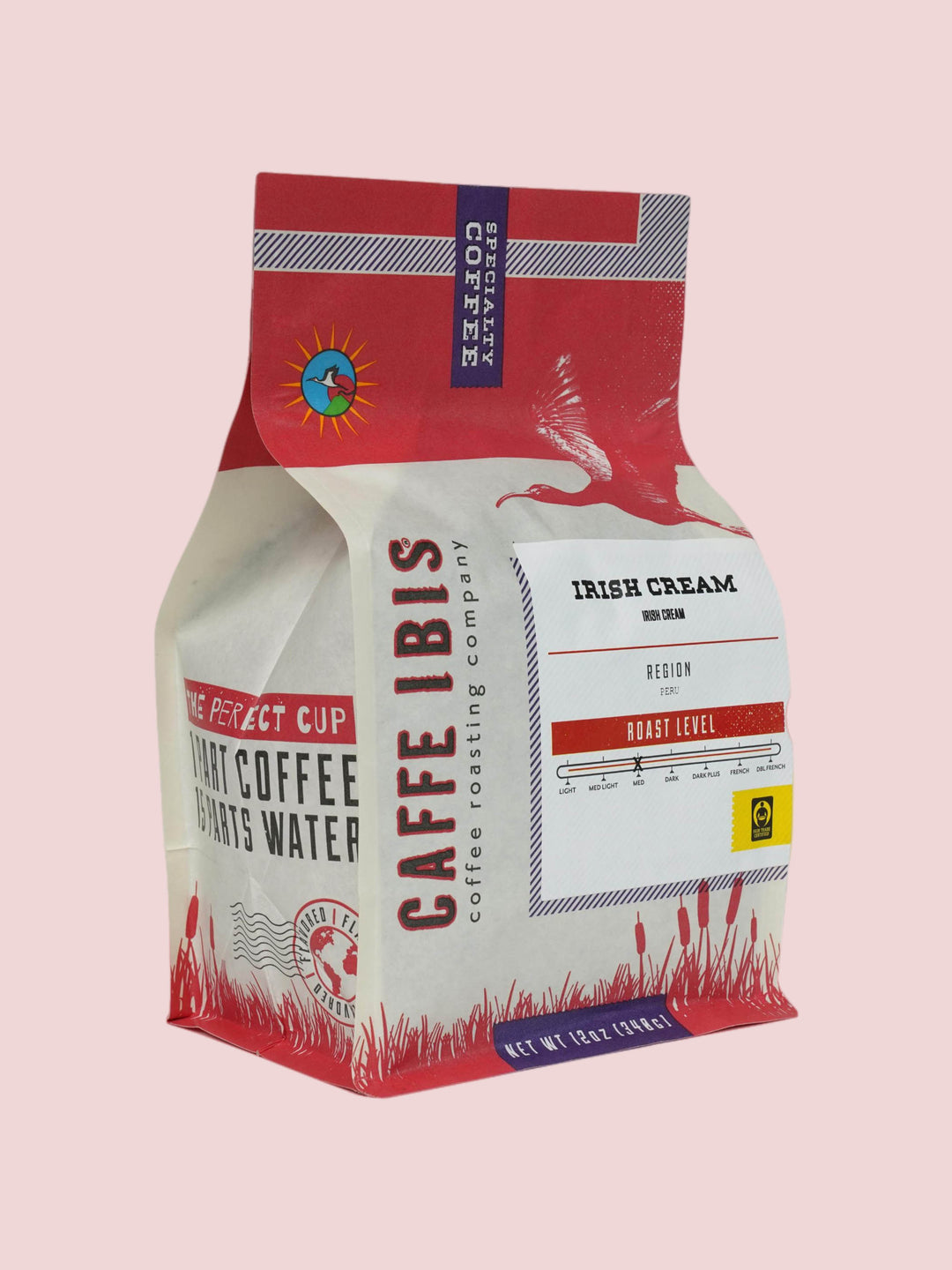 Caffe Ibis flavor Irish Cream coffee in a pink twelve ounce bag; front quarter view.