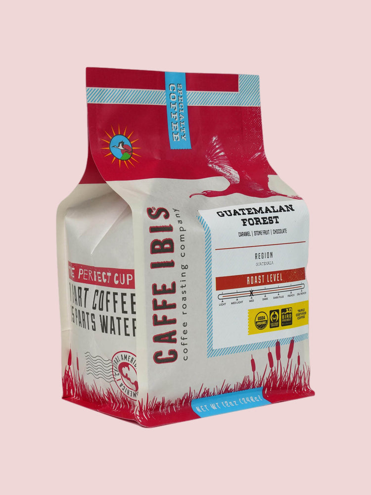 Caffe Ibis Organic Guatemalan Forest coffee in a red twelve ounce bag, front quarter view.