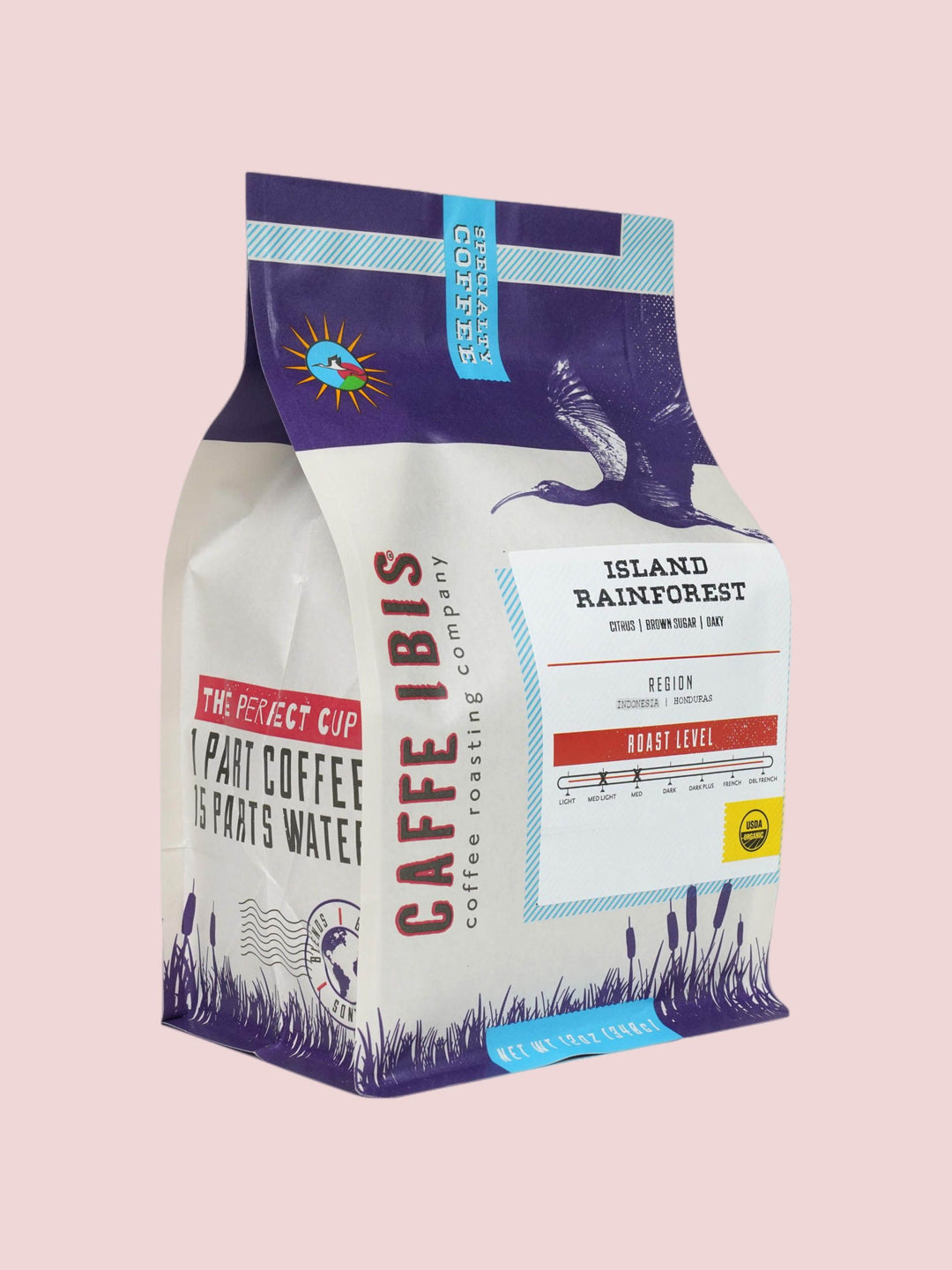 Caffe Ibis Organic Island Rainforest coffee in a purple twelve ounce bag; front quarter view.