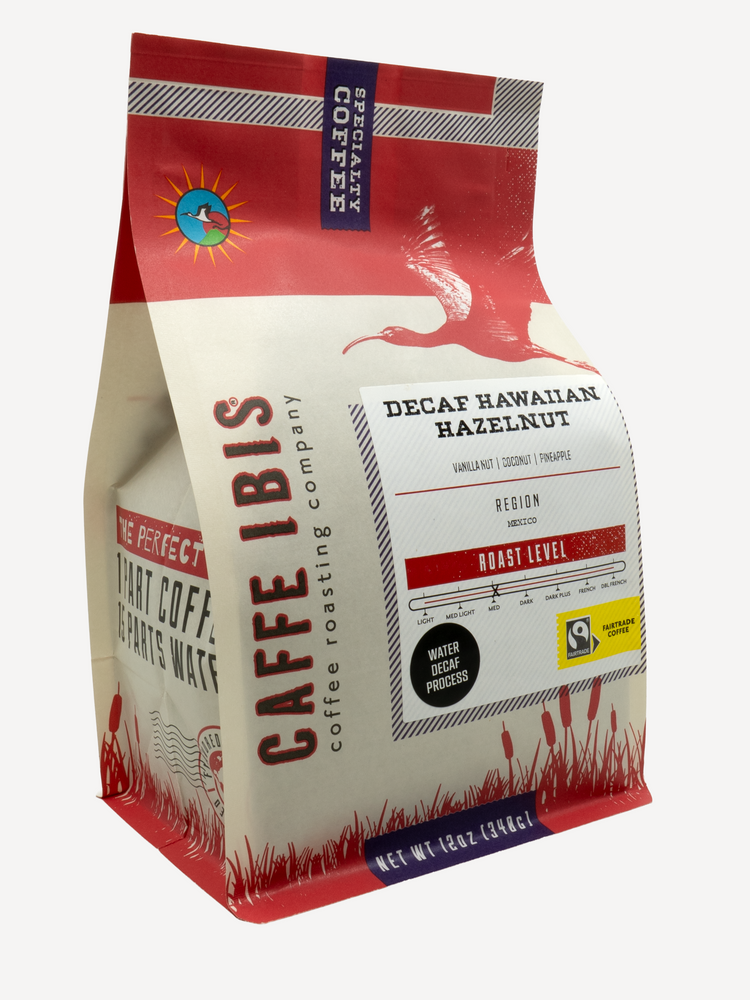 Caffe Ibis Decaf Hawaiian Hazelnut flavored coffee in a red twelve ounce bag; front quarter view.