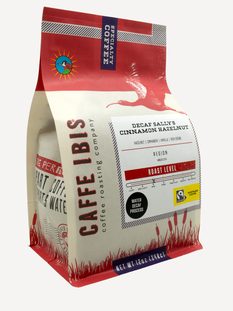 Caffe Ibis Decaf Sally's Cinnamon Hazelnut flavored coffee in a red twelve ounce bag; front quarter view.