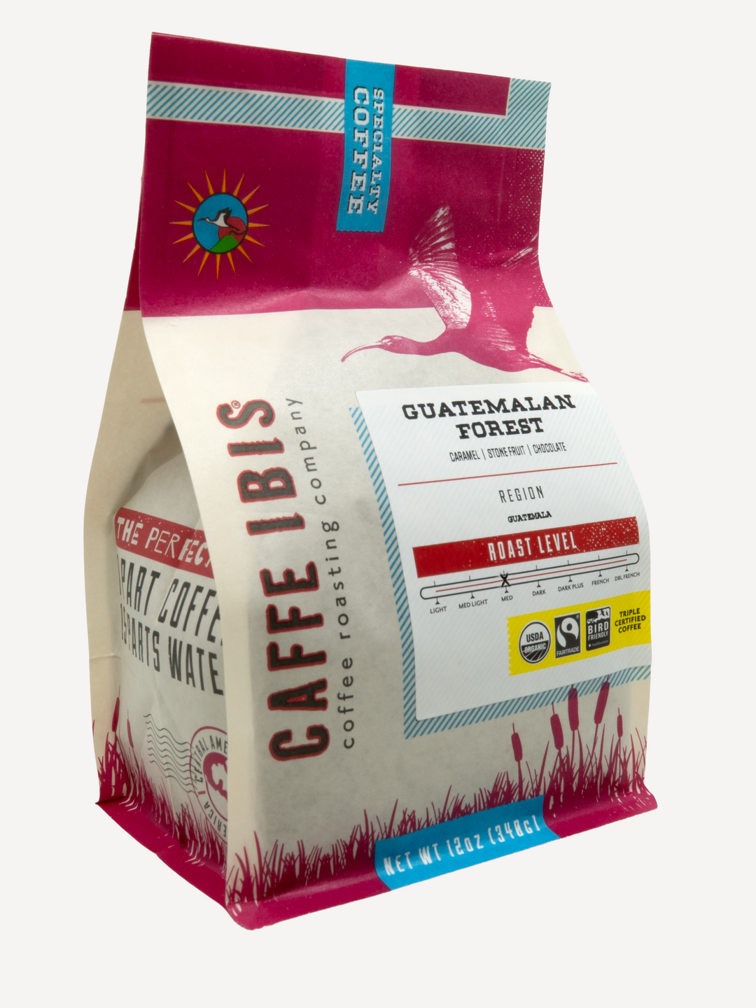 Caffe Ibis Organic Guatemalan Forest coffee in a pink twelve ounce bag, front quarter view.