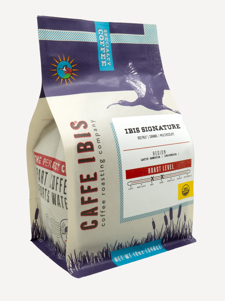 Caffe Ibis Organic Ibis Signature coffee in a purple twelve ounce bag; front quarter view.