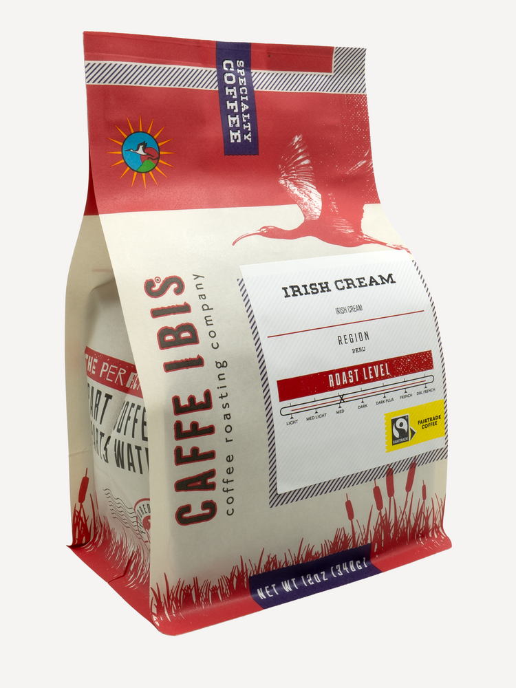 Caffe Ibis flavor Irish Cream coffee in a pink twelve ounce bag; front quarter view.