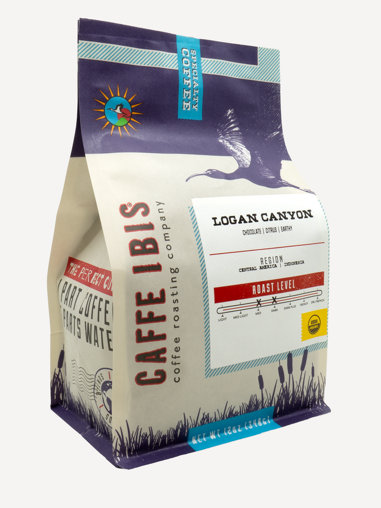 Caffe Ibis Organic Logan Canyon coffee in a purple twelve ounce bag; front quarter view.