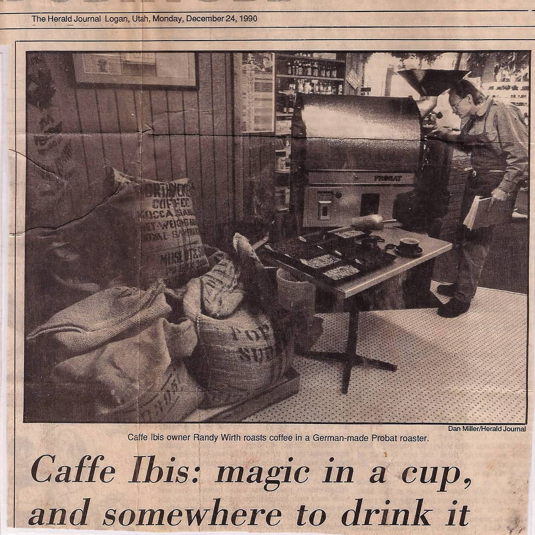 Text: The Herald Journal, Logan, Utah, Monday, December 24, 1990. Caffe Ibis owner Randy Wirth roasts coffee in German-made Probat roaster. Caffe Ibis: magic in a cup, and somewhere to drink it; Old newspaper clipping with image of Randy roasting coffee.