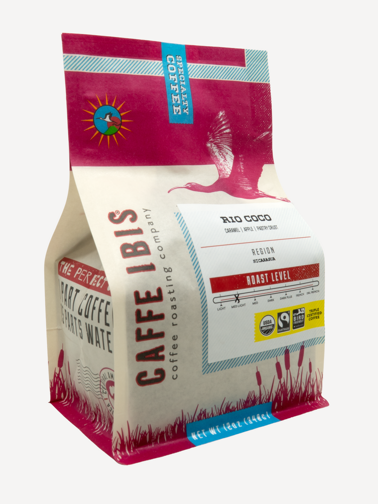Caffe Ibis Organic Rio Coco coffee in a pink twelve ounce bag; front quarter view.