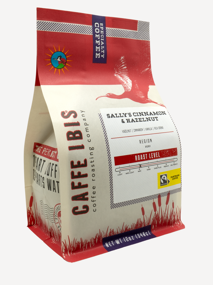 Caffe Ibis flavored Sally's cinnamon hazelnut and cream coffee in a red twelve ounce bag; front quarter view.