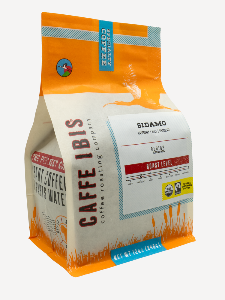Caffe Ibis Organic Sidamo coffee in an orange twelve ounce bag; front quarter view.
