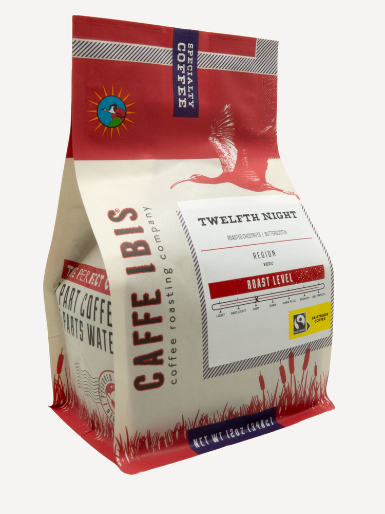 Caffe Ibis seasonal flavored Twelfth Night (Holiday Chestnut) coffee in a red twelve ounce bag; front quarter view.