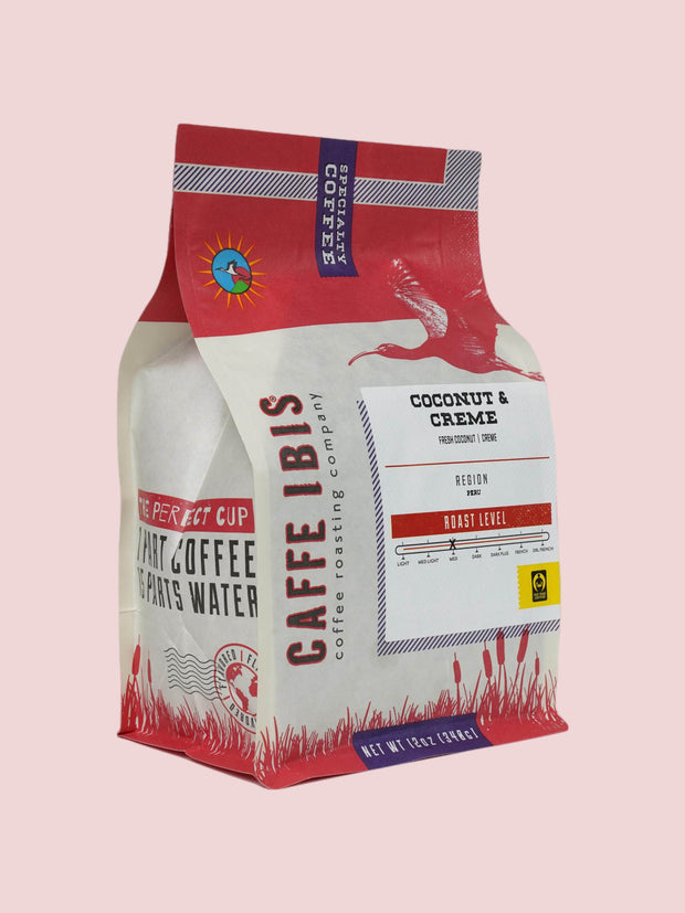 Caffe Ibis Coconut & Creme flavored coffee in a brown twelve ounce bag; front quarter view.
