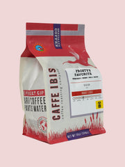 Caffe Ibis seasonal flavor Frosty's Favorite coffee in a pink twelve ounce bag; front quarter view.
