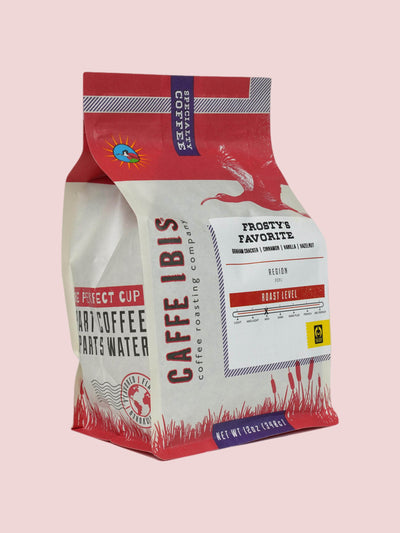 Caffe Ibis seasonal flavor Frosty's Favorite coffee in a pink twelve ounce bag; front quarter view.