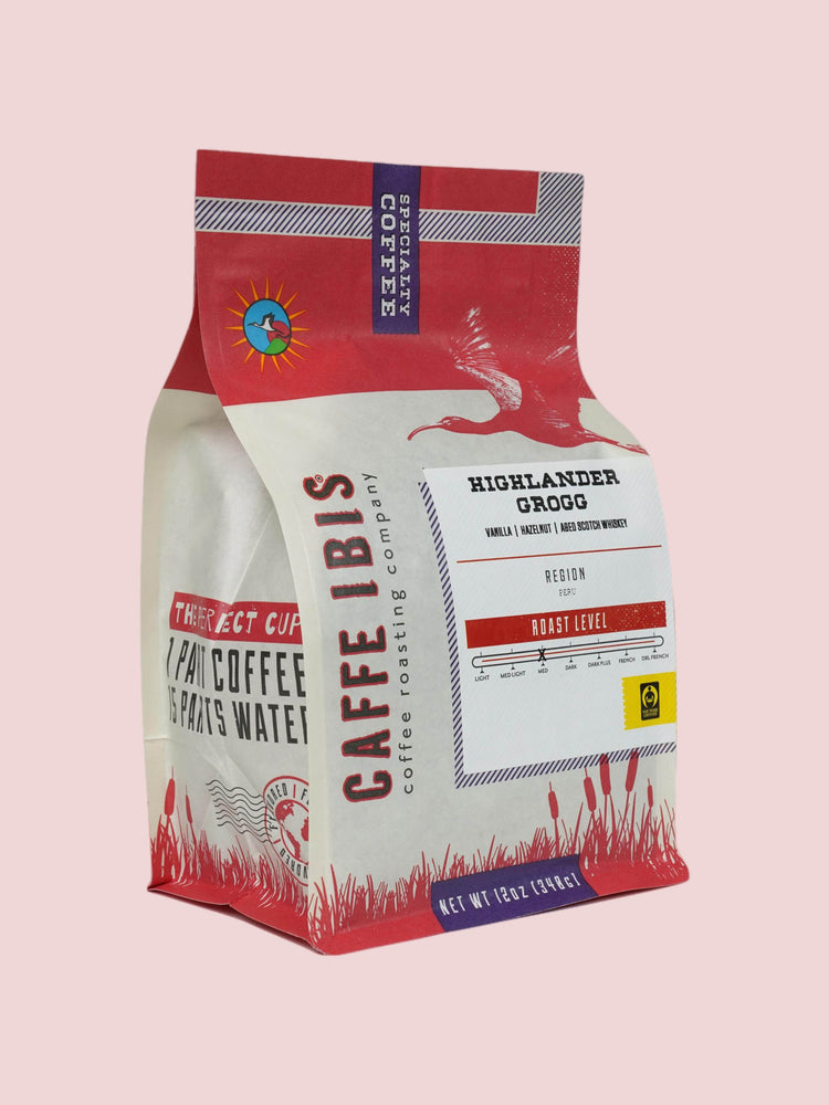 Caffe Ibis flavor Highlander Grogg coffee in a pink twelve ounce bag; front quarter view.