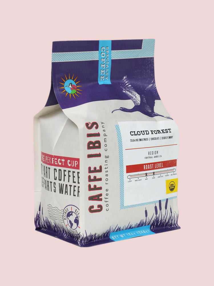 Caffe Ibis Organic Cloud Forest coffee in a purple twelve ounce bag; front quarter view.