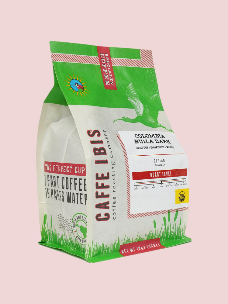 Caffe Ibis Organic Colombia Huila Dark coffee in a green twelve ounce bag; front quarter view.