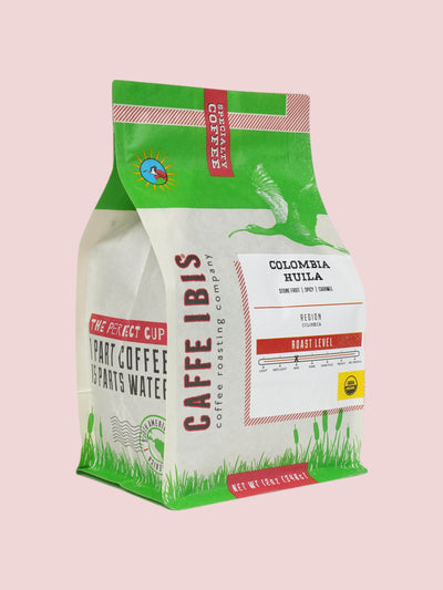 Caffe Ibis Organic Colombian Huila coffee in a green twelve ounce bag; front quarter view.