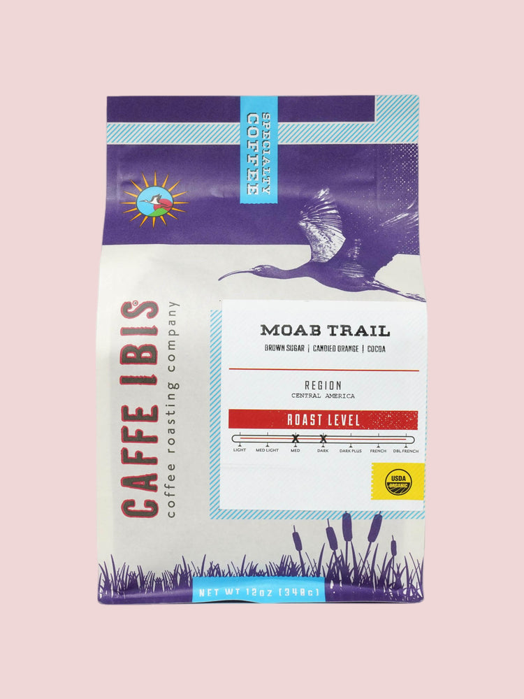 Caffe Ibis Organic Moab Trail coffee in a purple twelve ounce bag; front quarter view.