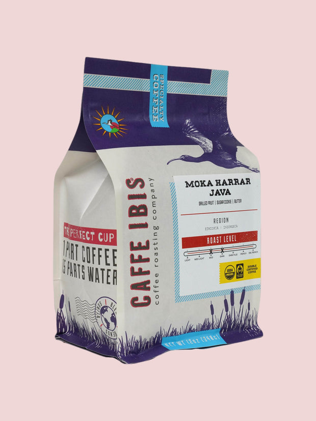 Caffe Ibis Organic Moka Harrar Java coffee in a purple twelve ounce bag; front quarter view.
