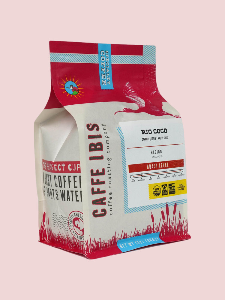 Caffe Ibis Organic Rio Coco coffee in a red twelve ounce bag; front quarter view.