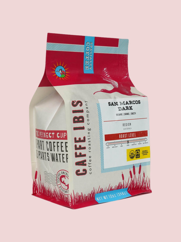 Caffe Ibis Organic San Marcos Dark in a red twelve ounce bag; front quarter view.