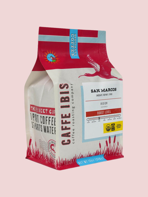  Caffe Ibis organic San Marcos coffee in a green twelve ounce bag; front quarter view.