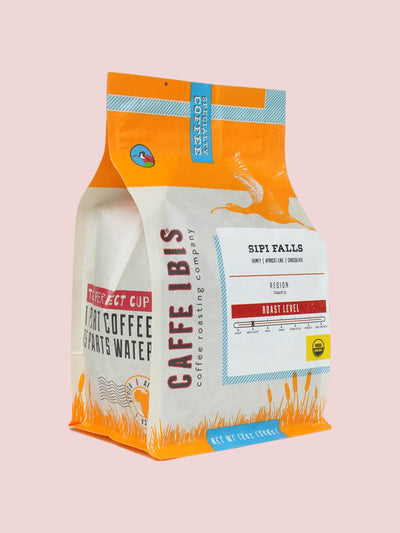 Caffe Ibis Organic Sipi Falls coffee in a orange twelve ounce bag; front quarter view.